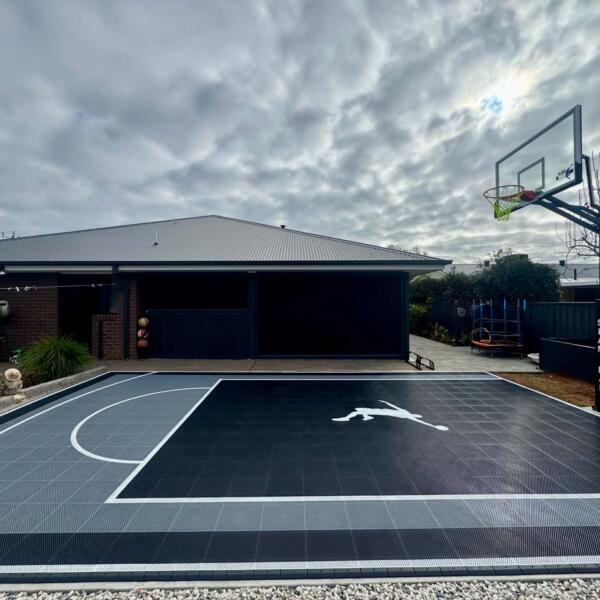 Custom Slam Man basketball court in Swan Hill with black key, grey outer and 60 inch ring