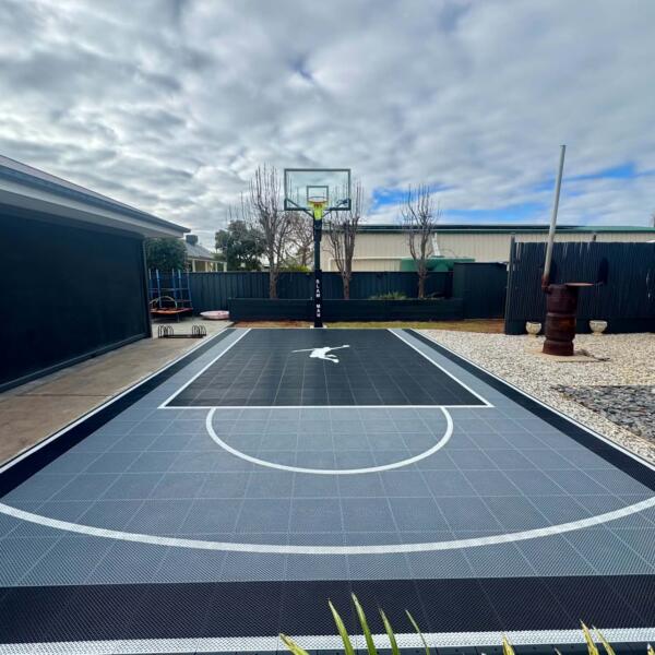 Custom backyard basketball court in Swan Hill Victoria with Slam Man Elite 60 inch ring and glow in the dark lines