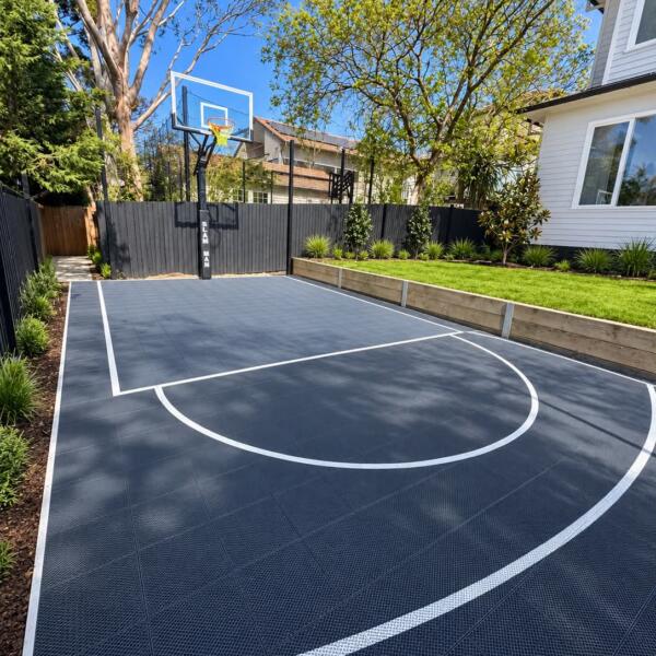 Custom Slam Man Elite basketball court with 60 inch ring installed in Rosanna