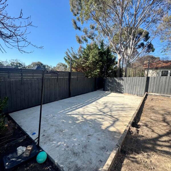 Before photo of backyard concrete base before Slam Man basketball court installation in Rosanna