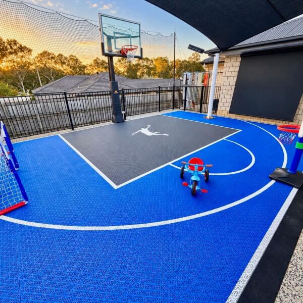 DIY Slam Man Pro Cushion basketball court kit installed in Logan Village Queensland with blue outer tiles and light grey key
