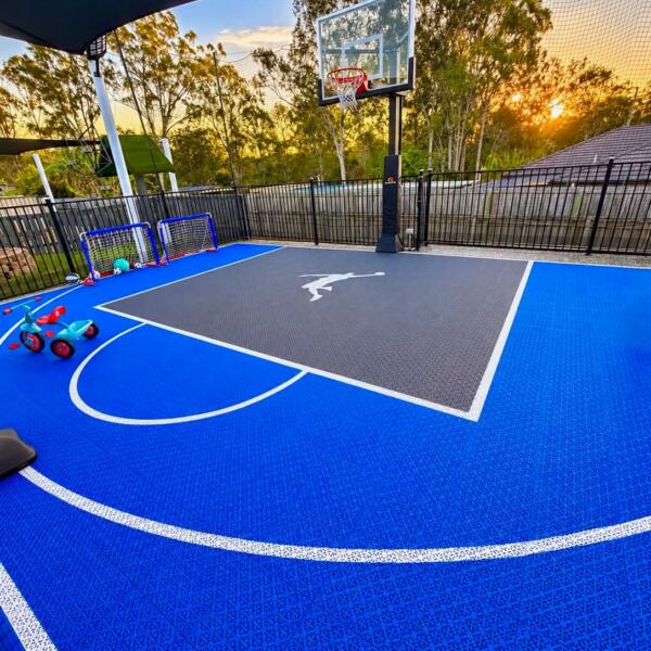 Slam Man Pro Cushion backyard basketball court in Logan Village with glow line markings and Slam Man logo